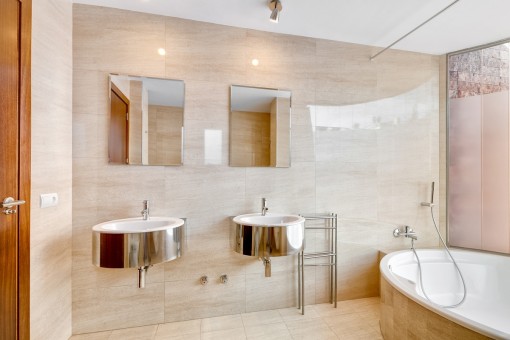 Noble bathroom with bathtub and natural light